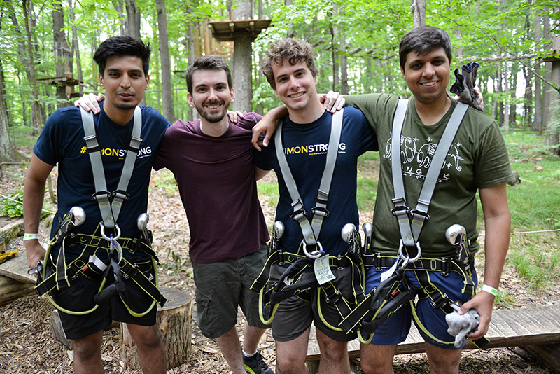 Simon Business School students participate in a ropes course team-building activity.