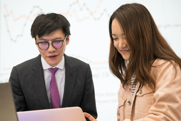 "MS Marketing Analytics Professor Huang teaching a student"