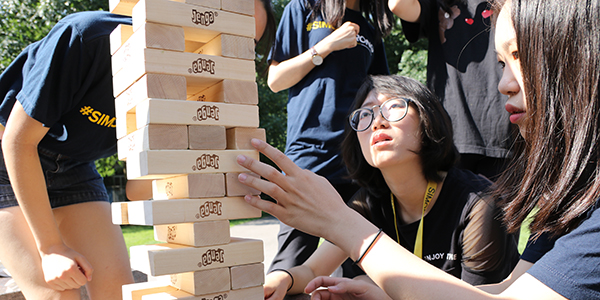 Simon Students Playing a Block Game
