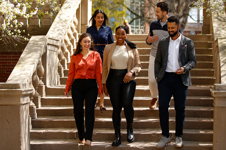 Students walking down staircase outdoors