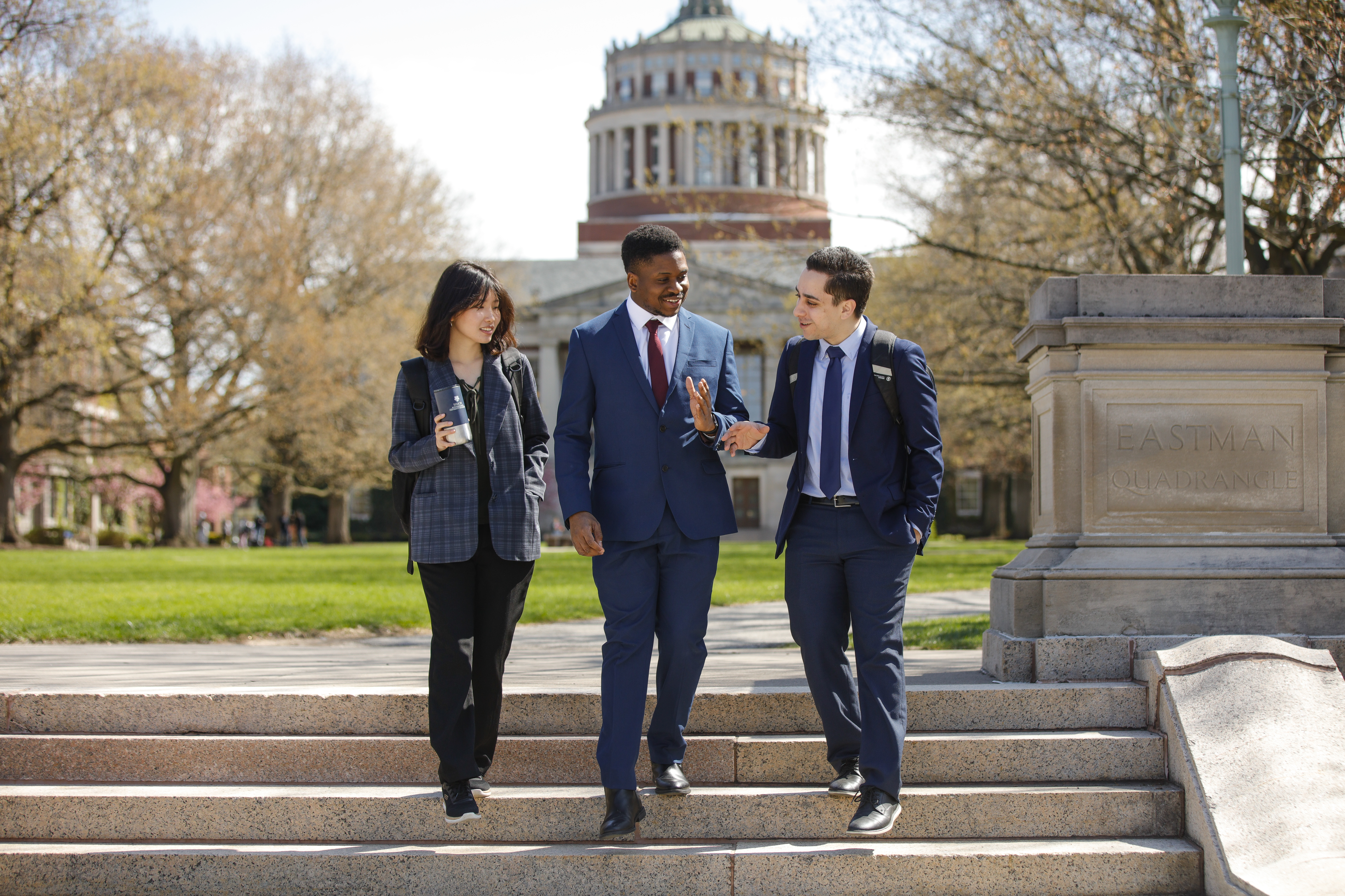Business students walking down the quad steps