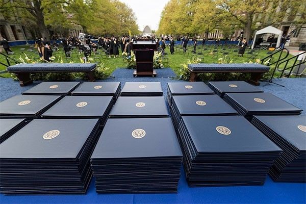 Diplomas are handed out to MS and MBA graduates at Simon Business School's 2022 commencement ceremony