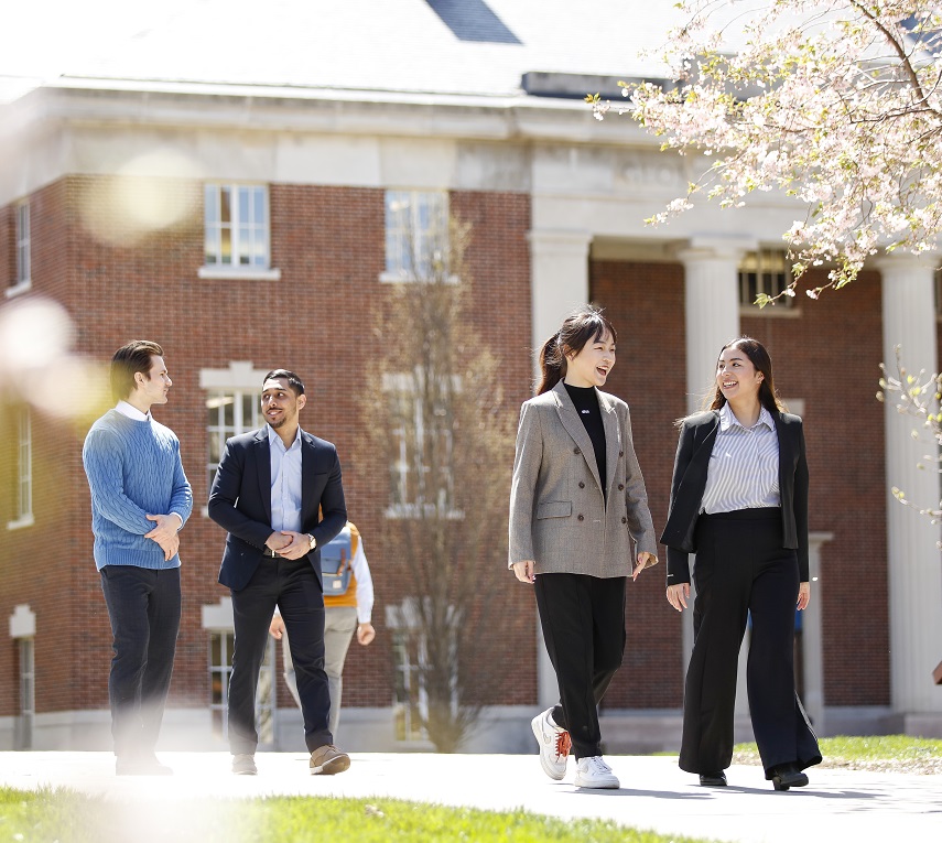 Students walking and chatting outdoors on campus